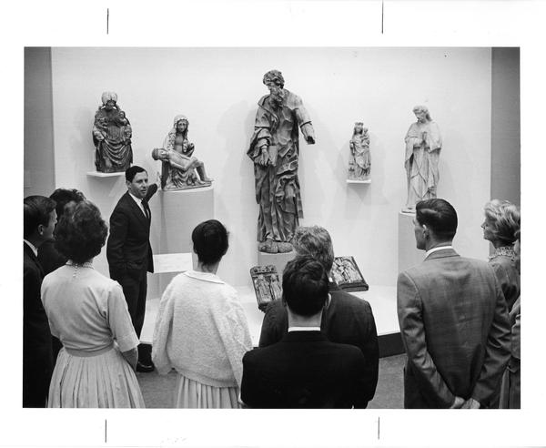 Presenter and audience at sculpture exhibit