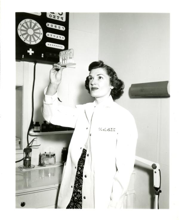 Frances Miller of the Atomic Energy Project holds up an atomic radiation indicator