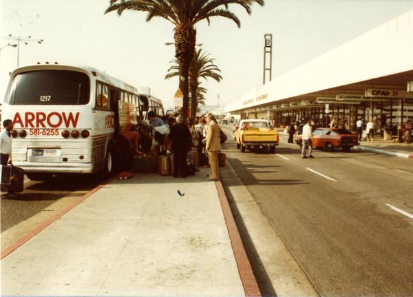 Band members disembarking Arrow charter bus at airport