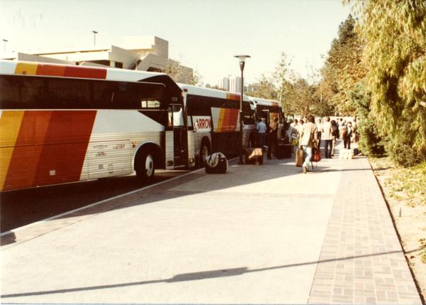 Band members boarding Arrow charter bus at UCLA