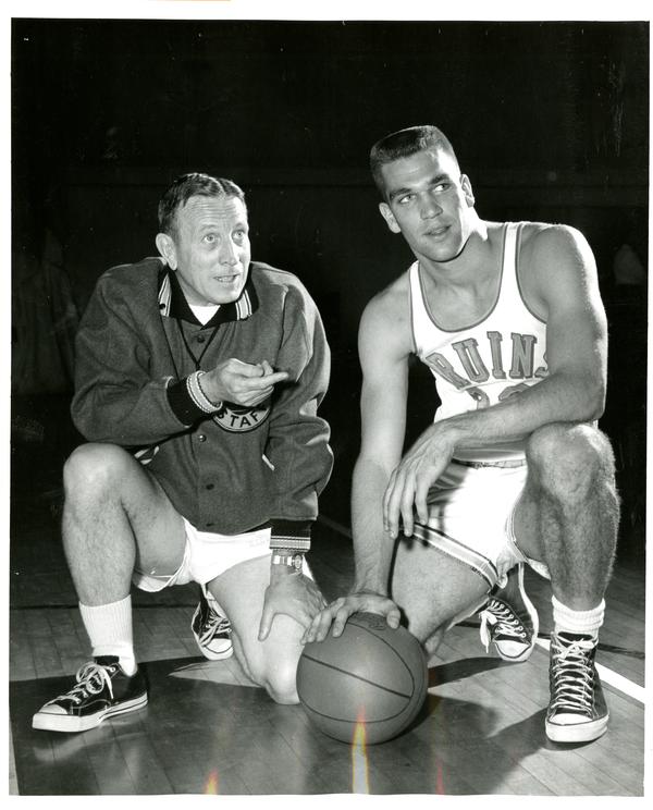 John Wooden conversing with Kent Miller on the court, March 1960