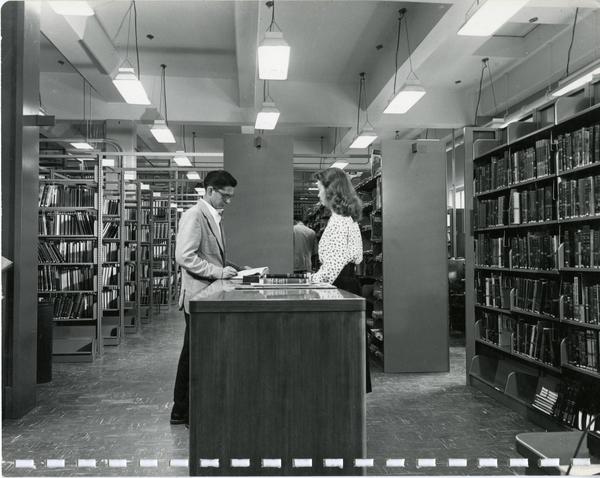Library patrons browsing shelves and Two men overseeing construction