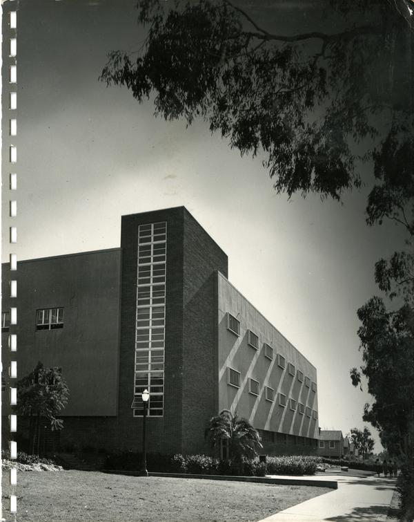 Double-sided image of Boelter Hall exterior; man standing in front of California map