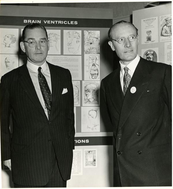 Macdonald Critchley and colleague in front of display on brain ventricles