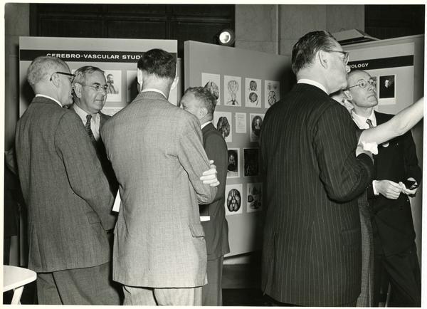 BRI researchers and physiologists conversing at an exhibition