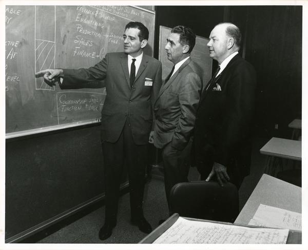 Participants conversing at chalkboard at California Newspaper Publishers Seminar, January 1966