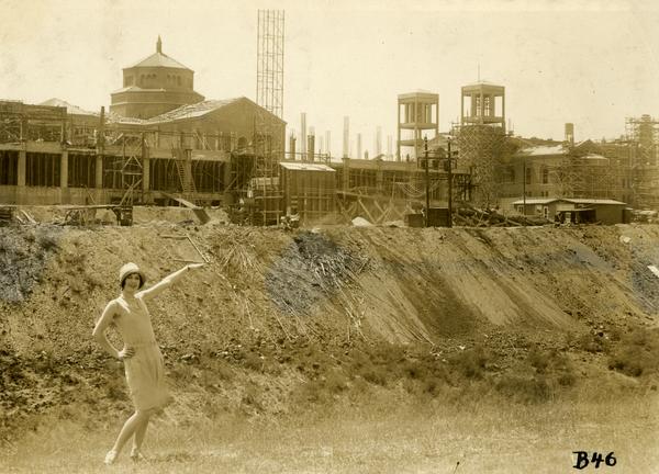 Woman posing in front of Campbell Hall construction site