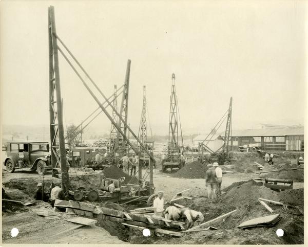 Construction zone with tall equipment and workers