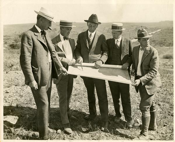 Herbert Foster, Robert Underhill, Stagg Gregg, and two other men looking at a map
