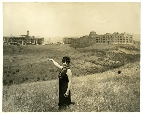 Woman in the foreground points towards the construction of Moore Hall
