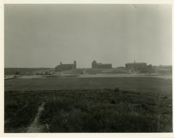 View of Royce Hall and Powell Library from athletic field, ca. 1930