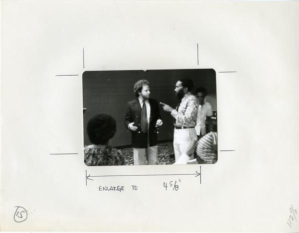Two men converse at an event for the Center for African American Studies