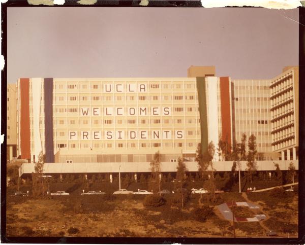 Residence Hall building displaying sign "UCLA Welcomes Presidents," Charter Day 1964