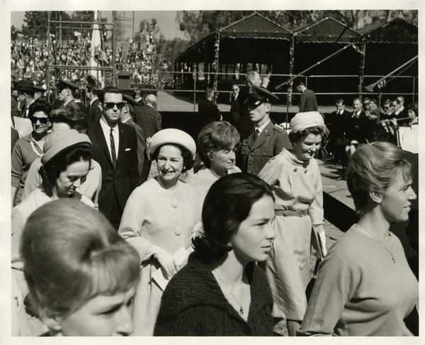 Lady Bird Johnson walking among a crowd of women on Charter Day 1964