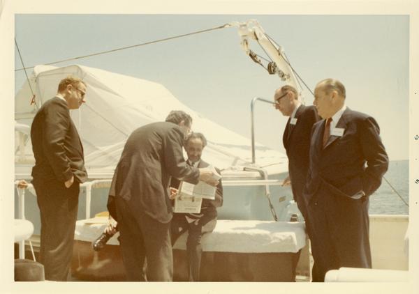 Emperor Haile Selassie of Ethiopia looking over documents on Motor Yacht Argo, 1967