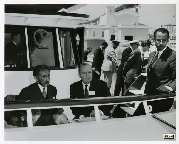 Emperor Haile Selassie with his dog and men sits at rail of Motor Yacht Argo, April 25, 1967