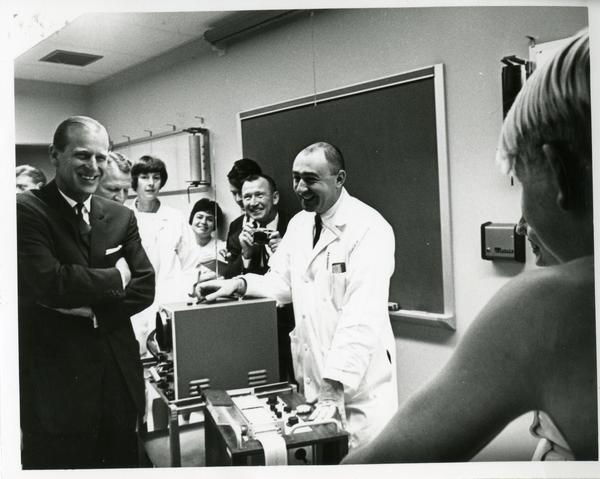 Prince Philip laughing with researchers