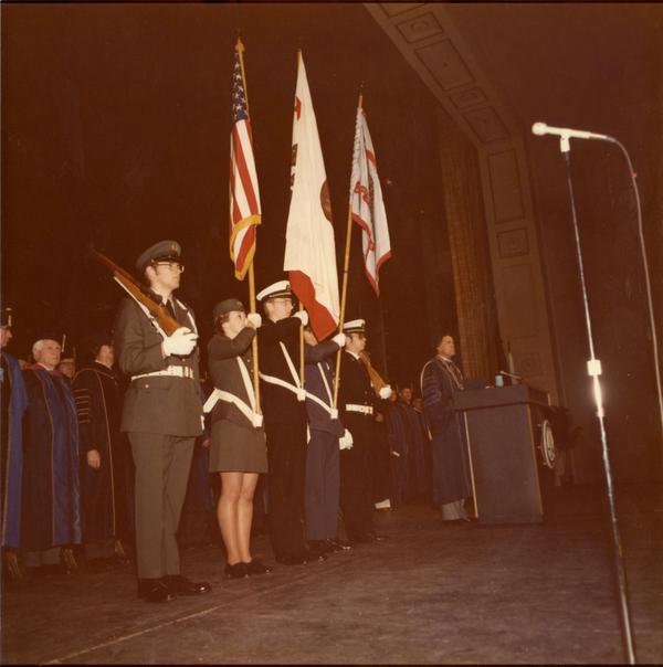 Color guard presenting arms in Royce Hall auditorium on Charter Day, 1975