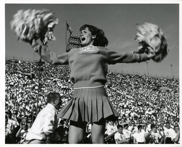 UCLA cheerleader yelling at the crowd at the football game, ca. 1965