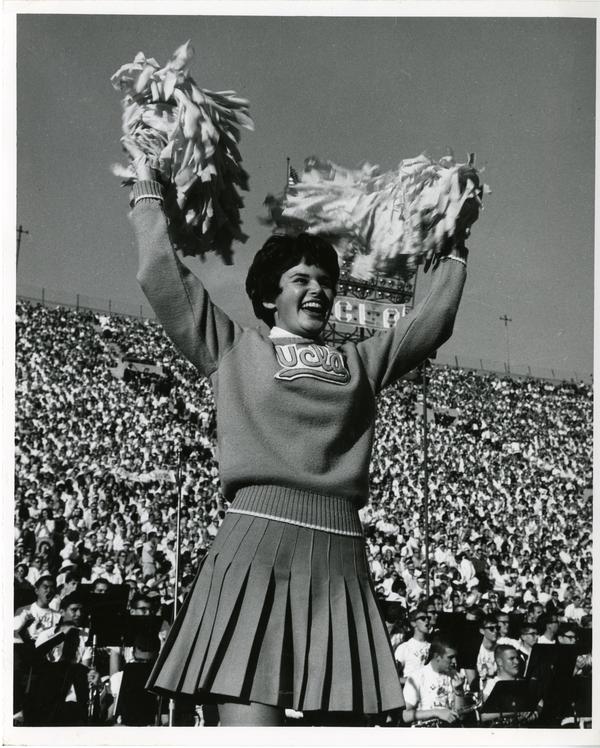 UCLA cheerleader performing at a football game, ca. 1960's
