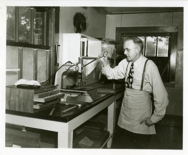 Employee working with equipment in the work room of the William Andrews Clark Library