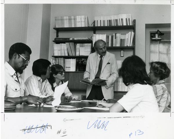 Instructor speaking with small group of students, circa 1980's