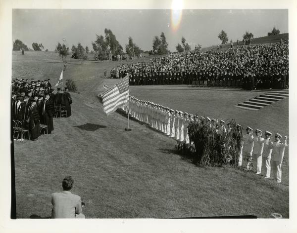 View of crowd during flag salute at Commencement, circa 1940's