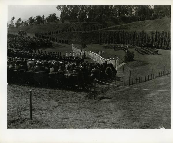 Graduates filing on stage for Commencement, circa 1940's