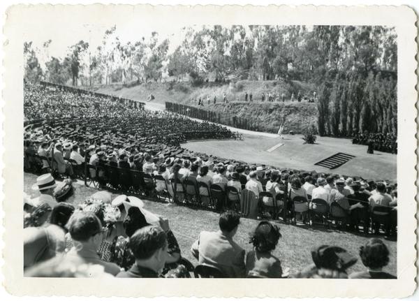View of audience looking towards stage at Commencement, circa 1940's