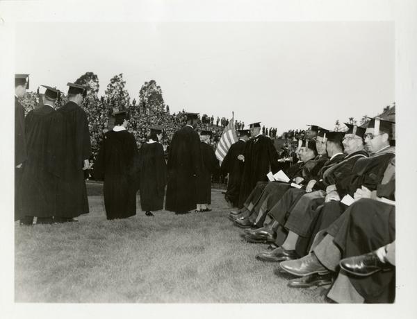 Graduates filing in towards the stage at Commencement, circa 1940's