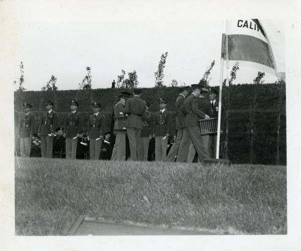 Members of the military filing on stage for Commencement, circa 1940's