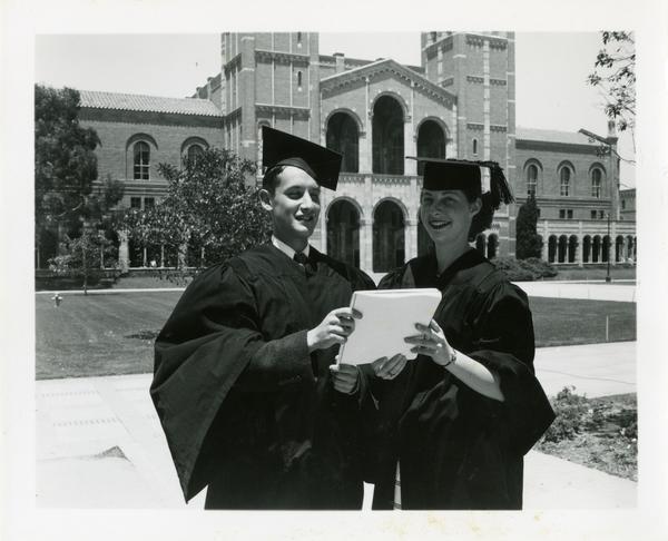 Two graduates pose after Commencement, circa 1950's