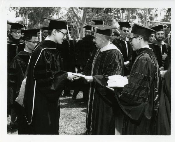 Student receiving his diploma at Commencement, 1964