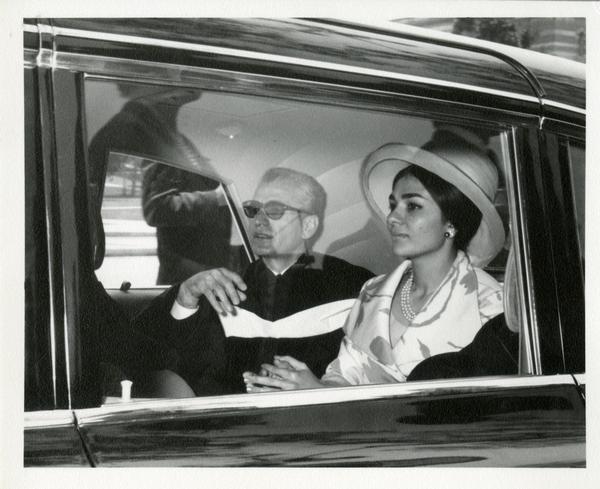 Mohammad Reza Pahlavi, the Shah of Iran, sitting in the car next to a woman at Commencement, 1964