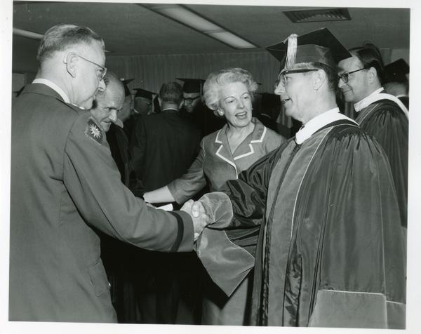 Faculty members shaking hands at Commencement, June 9, 1966