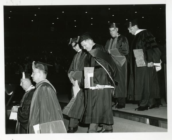 Faculty and administration members walking to stage at Commencement, June 9, 1966