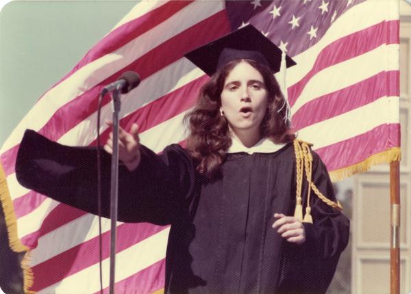 Song Leader Judith Blumin addressing the crowd at commencement, 1976