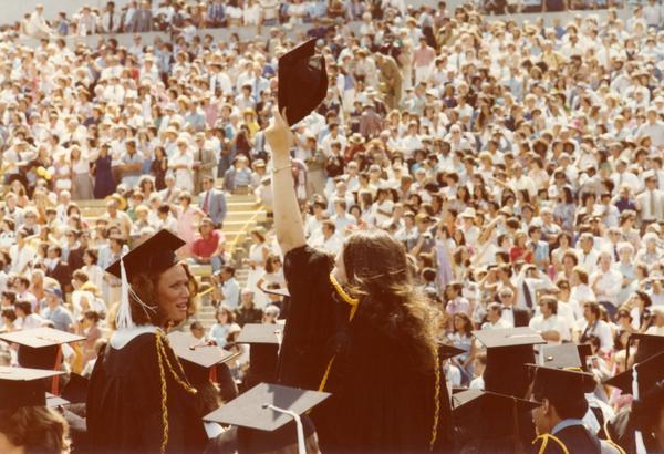 Graduate waves to those in the crowd at commencement, June 1979