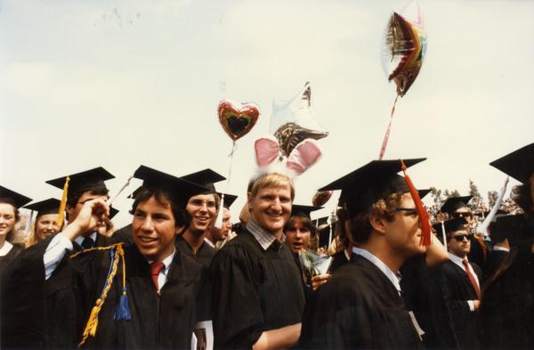 Graduates celebrating at commencement, ca. 1980's