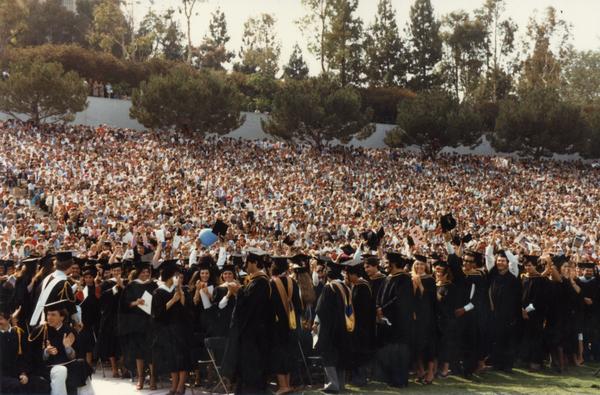 Graduates celebrating at commencement, ca. 1980's