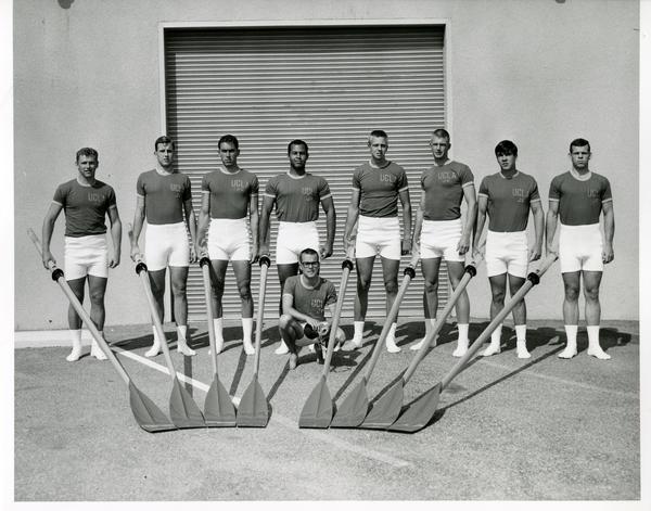 Members of the Crew team holding their rowing equipment