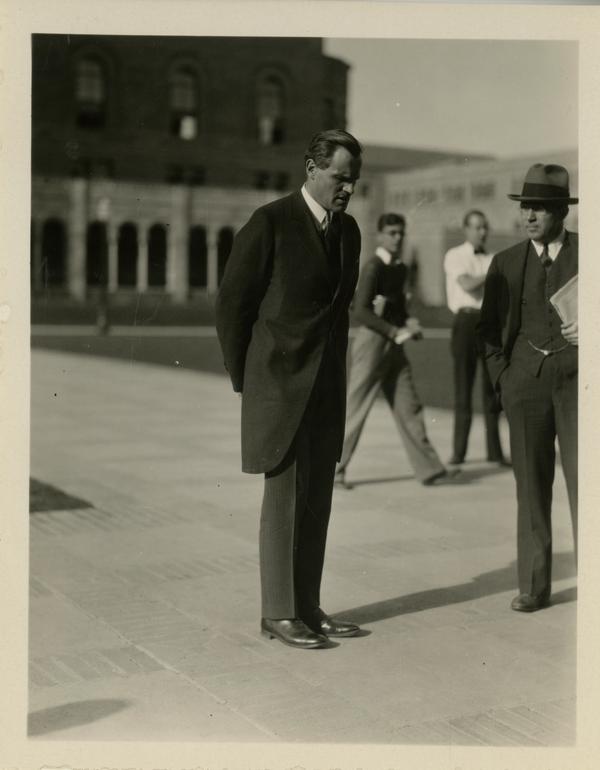 Unidentified guest at the dedication of the Westwood campus with view of Royce Hall in the background, March 1930