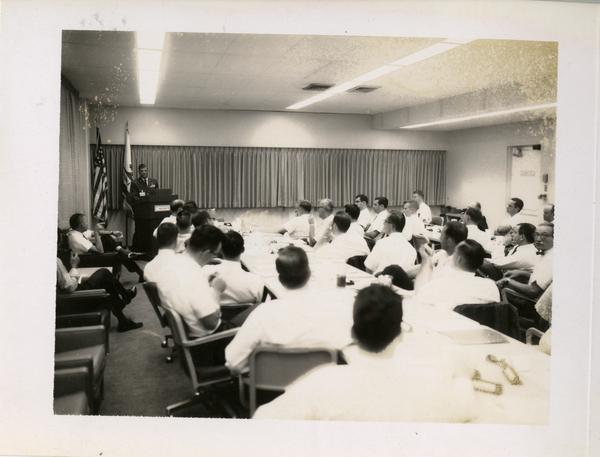 Members of the Defense Science Seminar listening to a speaker, ca. 1965