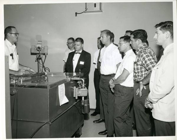 Members of the Defense Science Seminar looking at some equipment, ca. 1965