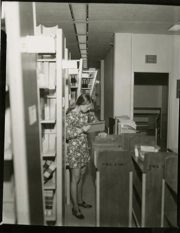 Library assistant cleans up after damage from the earthquake, 1971