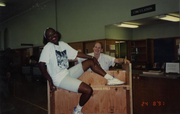 Student assistant and Maria Collins working on dismantling the Education/Psychology Library, 1991
