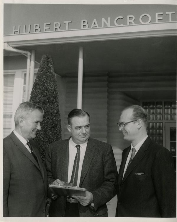 Harold L. Tallman, Carl Ehmann and Dr. Richard N. Baisden stand outside the Hubert Bancroft School