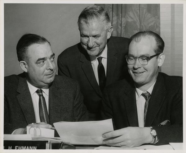 Harold L. Tallman, Carl Ehmann and Dr. Richard N. Baisden discuss plans for the expansion of classes to be held at Bancroft School