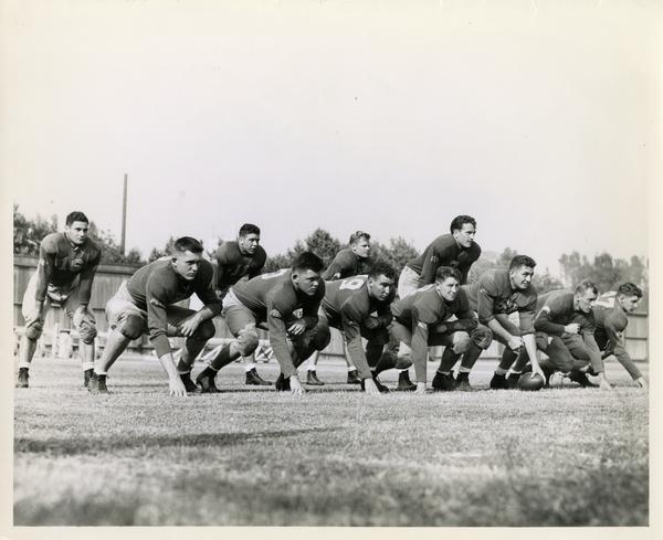 UCLA football players lined up during practice with Bob Waterfield as quarterback, 1944
