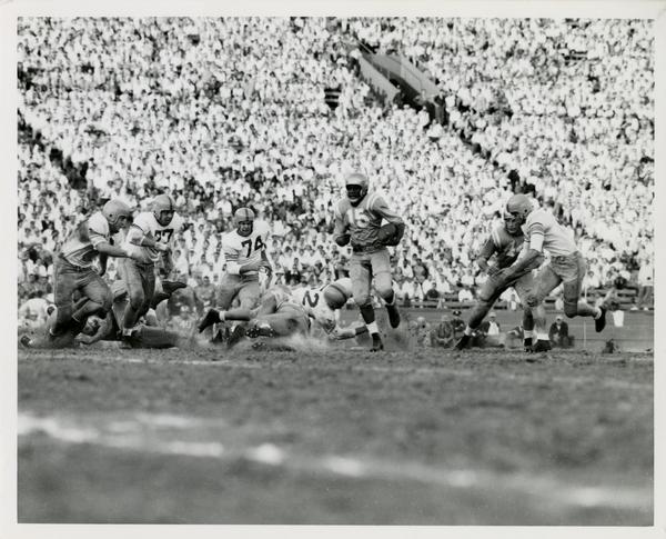 Football game action, ca. 1950s